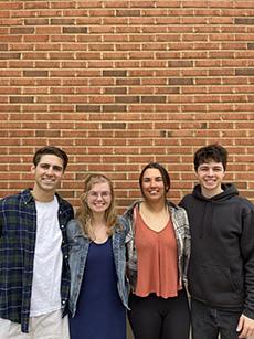 Matthew DiValerio, James Spriggs, Gabbie Kowalik, Mattie Zautner posed in front of a brick wall