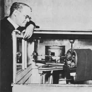 Brother George Rueppel, S.J., (left) and Father Macelwane, at the seismograph in the basement of DuBourg Hall. (1925)